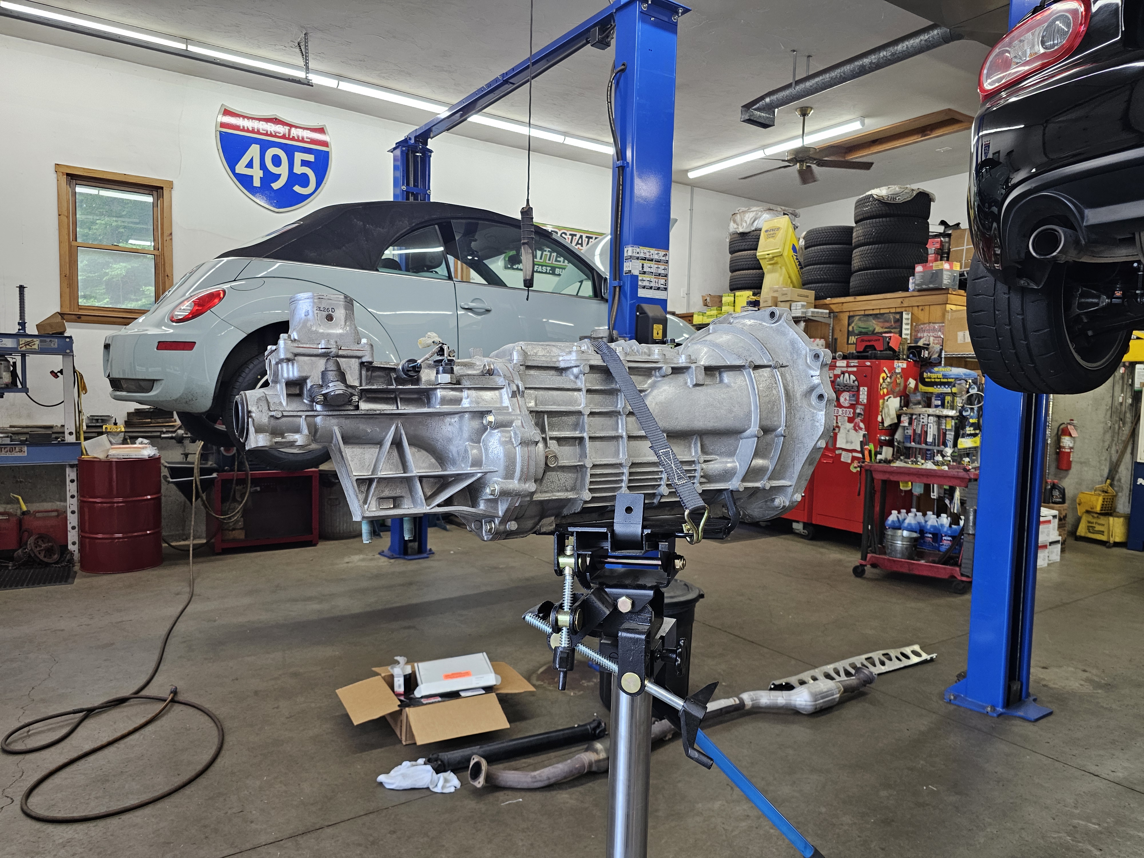 Transmission removed from VW Beetle on lift at Akin Automotive